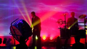 Two men on stage with purple backlighting at the Haygoods
